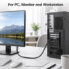 DisplayPort to HDMI cable connected from desktop PC to monitor in office setup