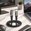 USB-C Extension Cable Connected to Laptop Monitor and Accessories in Modern Workspace Setup