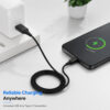 USB-A to USB-C braided cable charging a USB-C smartphone in a modern workspace