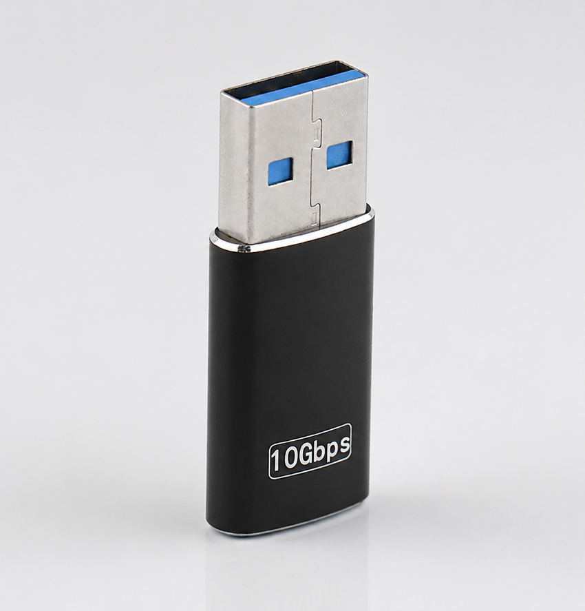 Black 10Gbps USB adapter displayed upright on a light gray background