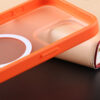 Camera corner detail of the orange UGOjP matte phone case for iPhone 15 series.